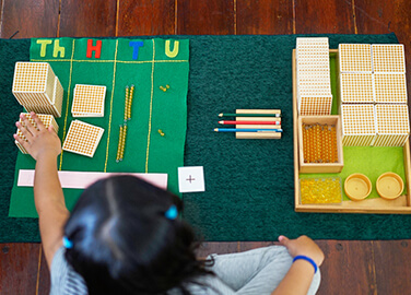 Preschool child working with Montessori materials