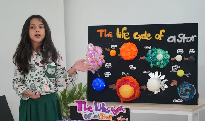 An Upper Elementary student presenting her Montessori final project